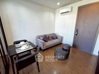 Cozy living room with modern furniture and air conditioning in a stylish apartment.
