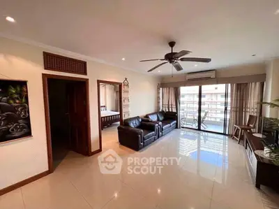 Spacious living room with modern decor and balcony access in a luxury apartment.