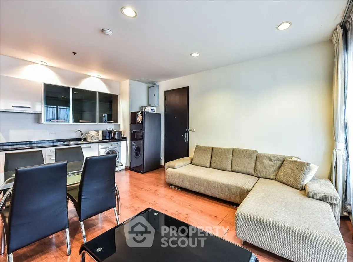 Modern living room with open kitchen and stylish furniture in a cozy apartment.