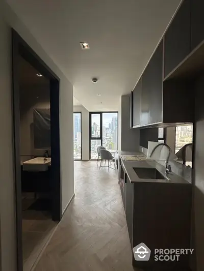 Modern kitchen with city view and sleek cabinetry