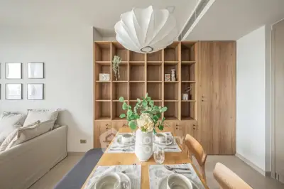 Modern dining area with stylish wooden shelving and elegant table setting
