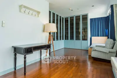 Spacious living room with elegant wooden flooring and stylish furniture