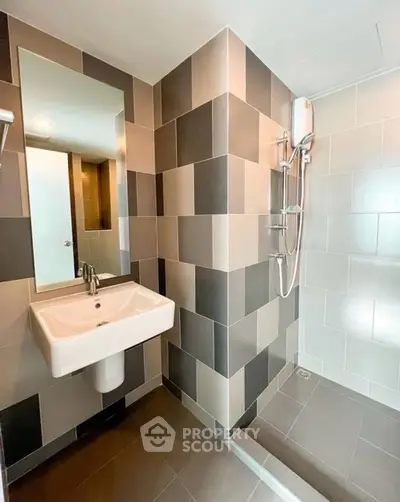 Modern bathroom with sleek tiles and contemporary fixtures in a stylish apartment.