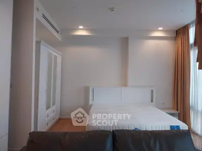 Spacious bedroom with modern furniture and natural light