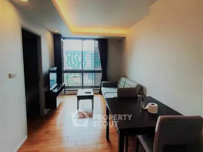 Modern living room with wooden flooring and large window view