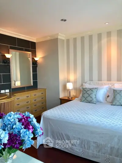 Elegant bedroom with stylish decor and cozy ambiance, featuring a comfortable bed and chic lighting.