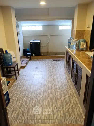 Spacious kitchen with tiled flooring and ample storage cabinets