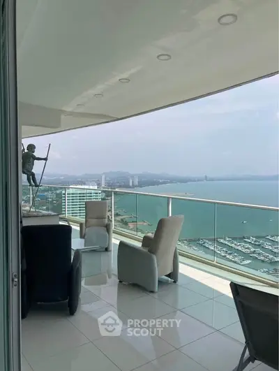 Luxurious balcony with stunning ocean view and modern seating area