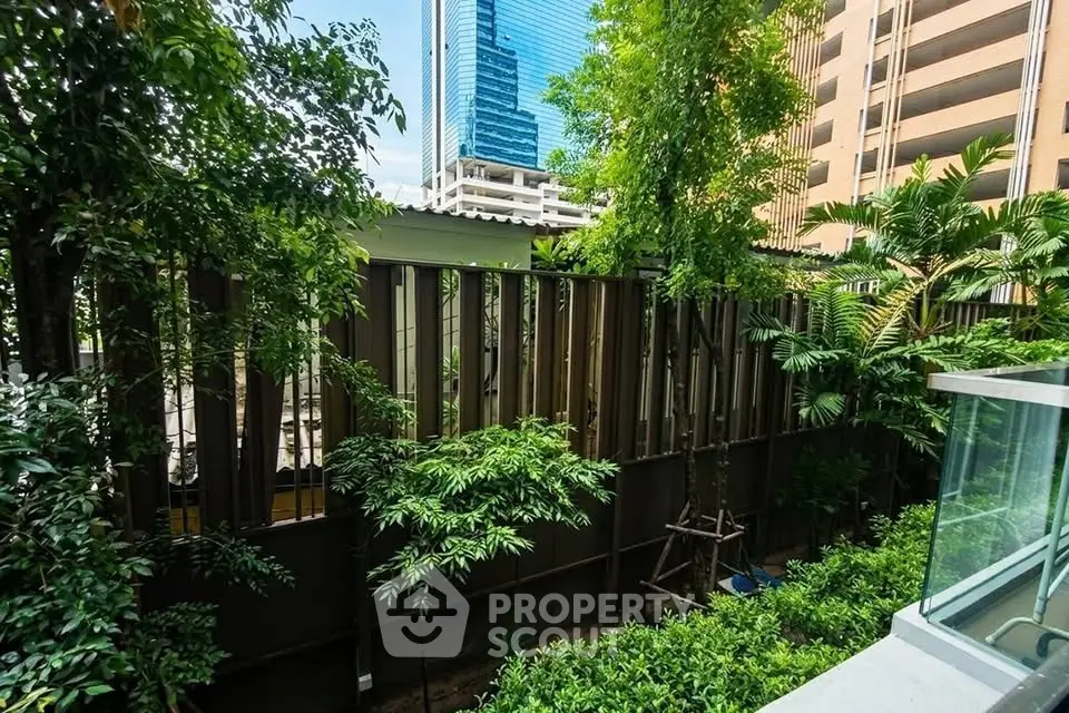 Lush garden view with modern high-rise buildings in the background, offering a serene urban oasis.