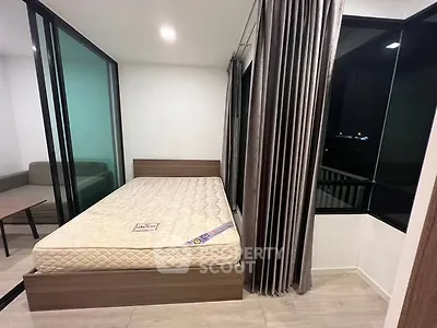 Modern bedroom with large windows and sleek design, featuring a comfortable bed and stylish curtains.