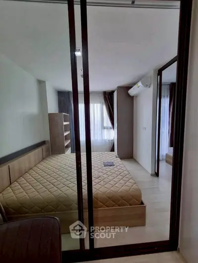 Modern bedroom with large mirrored wardrobe and natural light