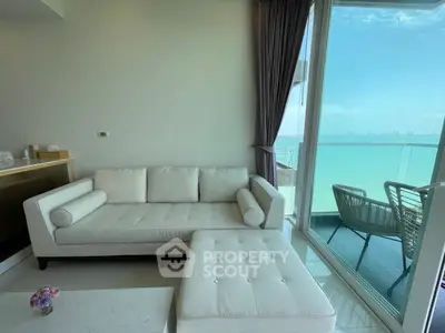 Modern living room with stunning ocean view and elegant balcony seating.