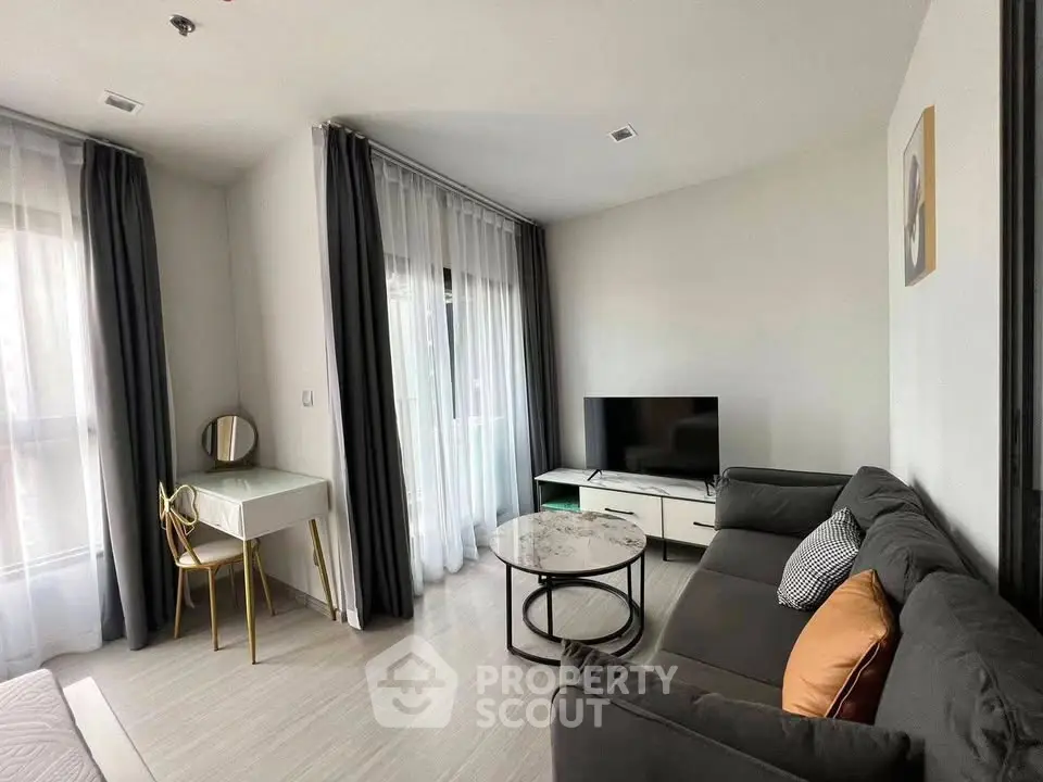 Modern living room with stylish furniture and natural light, perfect for relaxation and entertainment.