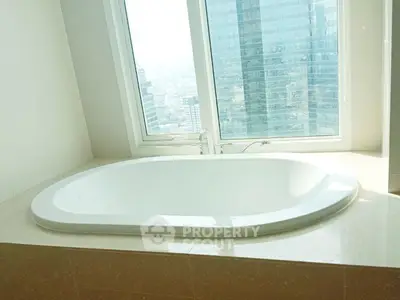 Luxurious bathroom with city view and elegant bathtub