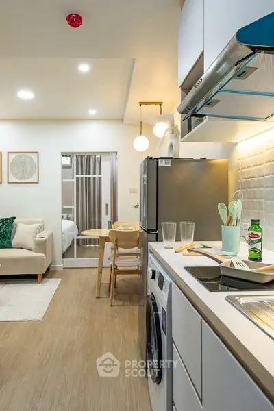 Modern open-plan kitchen and living area with stylish decor and appliances.