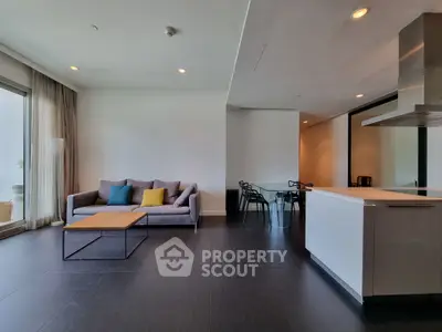 Modern open-plan living room with sleek kitchen and stylish decor