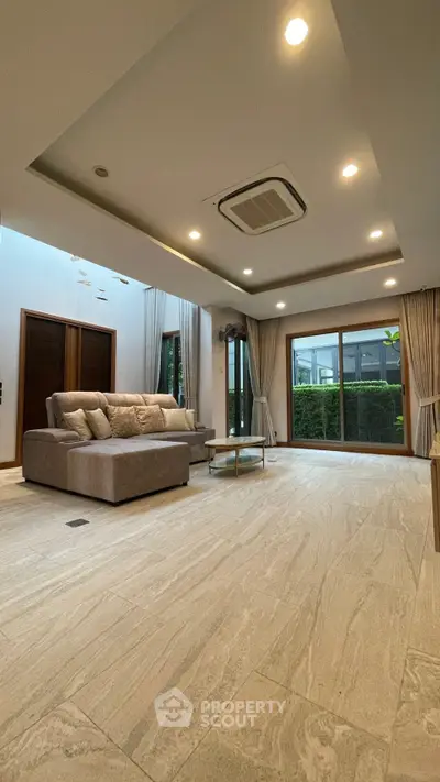 Spacious modern living room with large windows and elegant decor