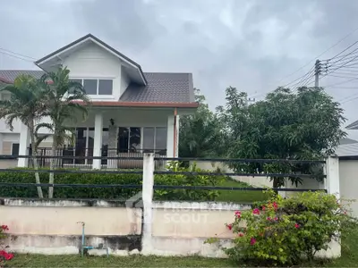 Charming suburban house with lush garden and modern architecture, perfect for family living.