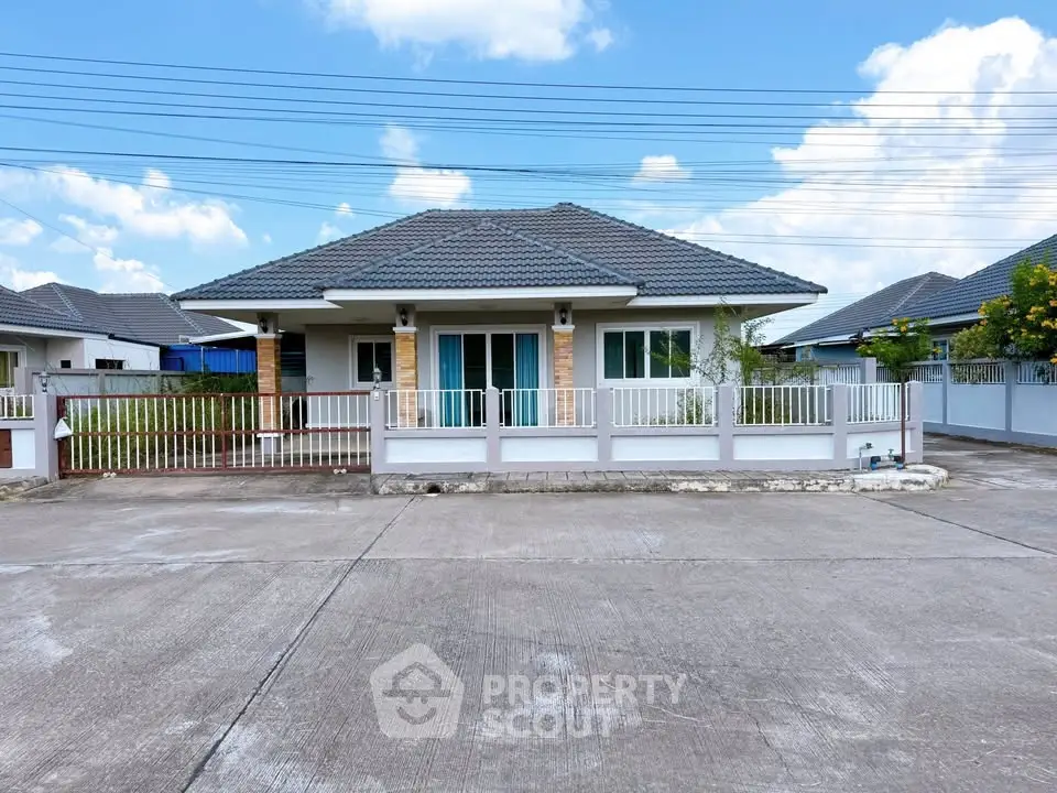 Charming single-story house with modern roof and fenced yard in a serene neighborhood.