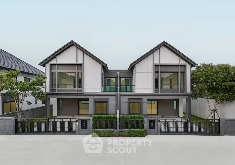 Modern duplex house with sleek design and spacious balconies in a serene neighborhood.
