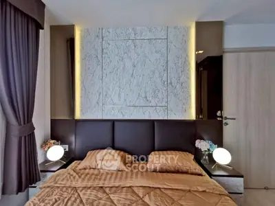 Luxurious bedroom with elegant marble accent wall and modern lighting, perfect for relaxation and comfort.