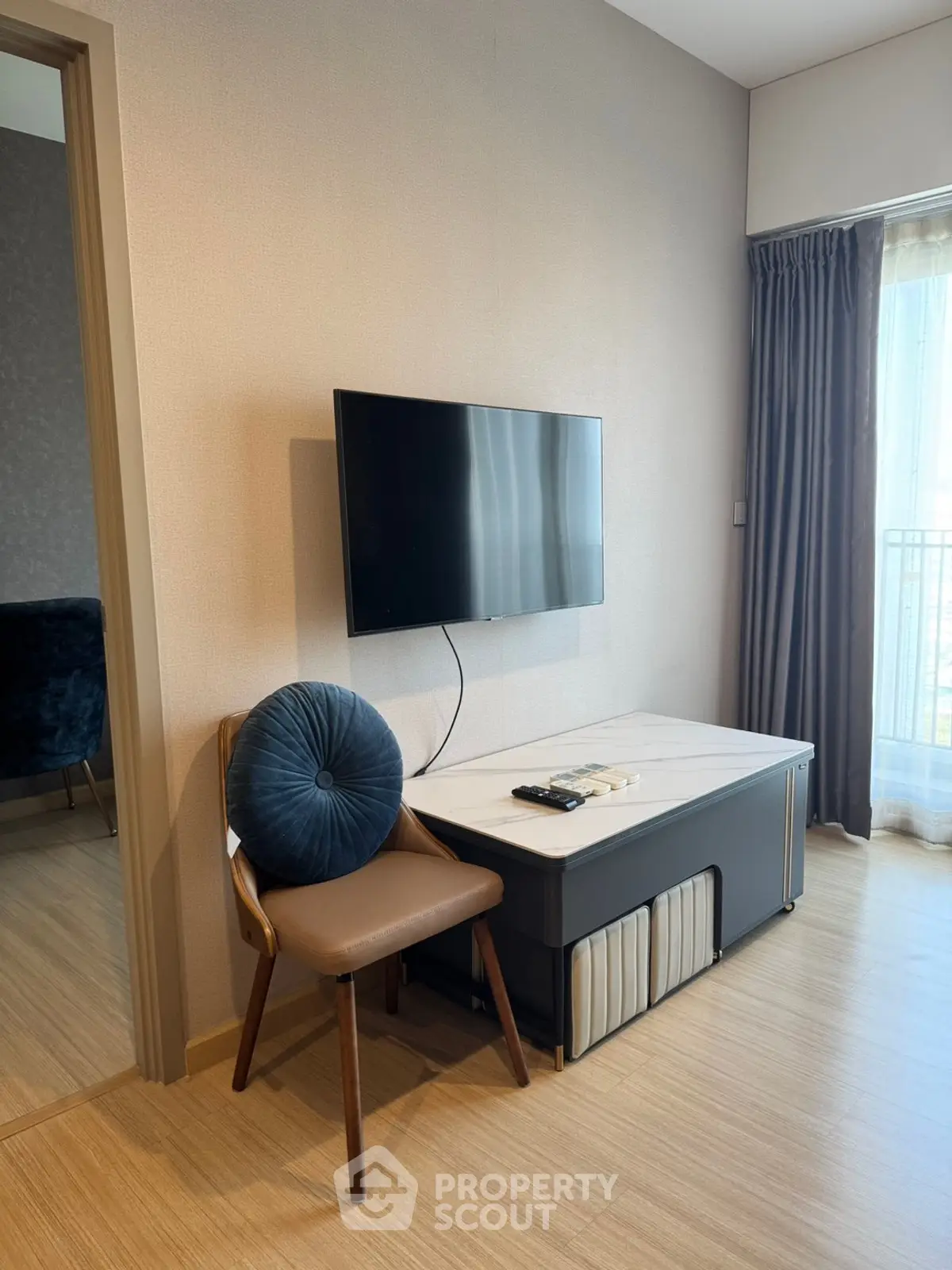 Modern living room with wall-mounted TV and stylish furniture