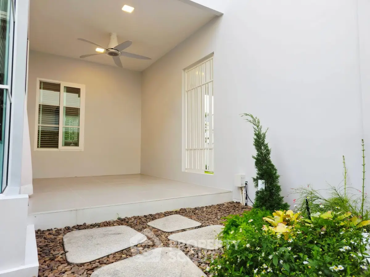Charming patio with garden view and modern design, perfect for relaxation and outdoor enjoyment.
