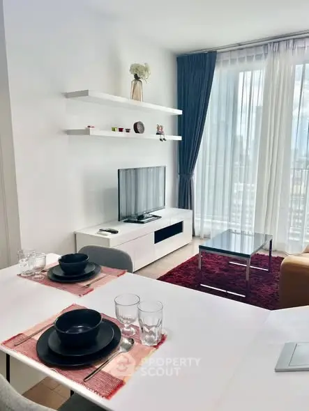 Modern living room with stylish decor and large windows offering city views
