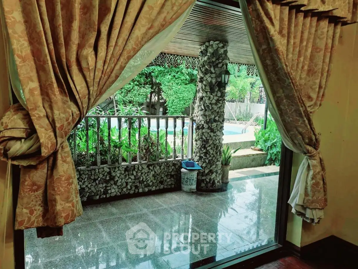 Luxurious home with elegant curtains and poolside view, perfect for relaxation and entertainment.