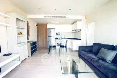 Modern open-layout living room with sleek kitchen and stylish furniture