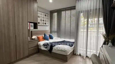 Modern bedroom with stylish decor and large windows for natural light.