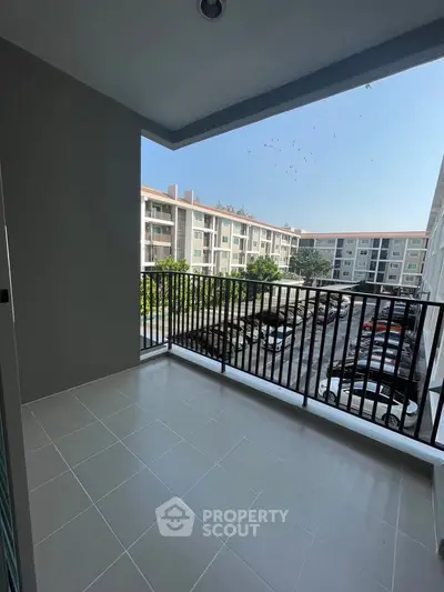 Spacious balcony with scenic view in modern apartment complex
