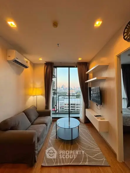 Modern living room with city view, featuring sleek furniture and ambient lighting.