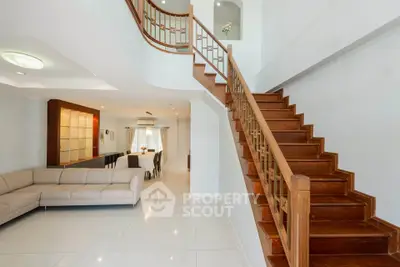 Spacious living room with elegant staircase and modern decor