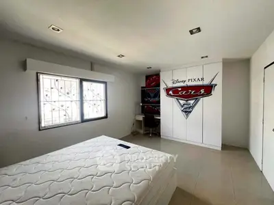 Spacious bedroom with Disney Pixar Cars theme and natural light.
