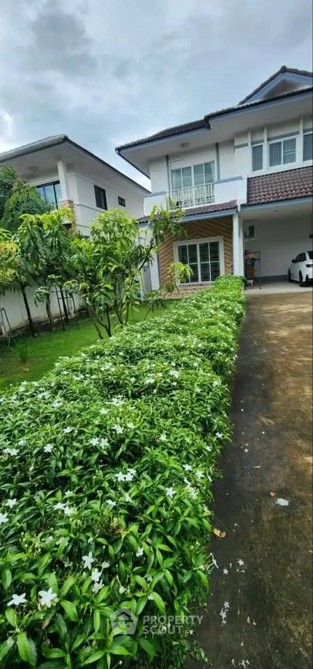 Charming suburban home with lush garden and driveway, perfect for family living.