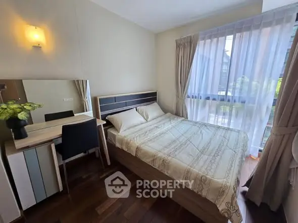 Cozy bedroom with natural light and elegant decor, featuring a comfortable bed and stylish furniture.