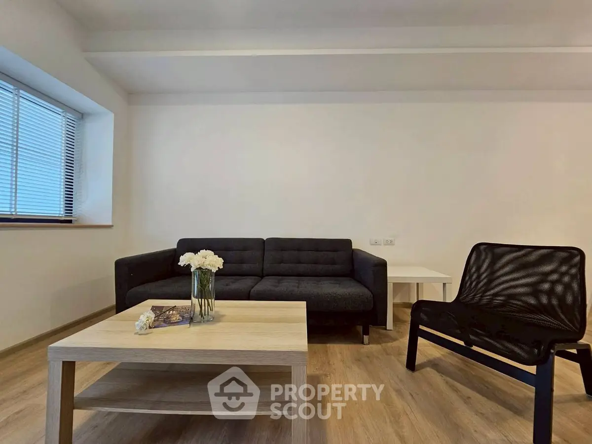 Modern living room with sleek furniture and wooden flooring, perfect for relaxation and entertaining.
