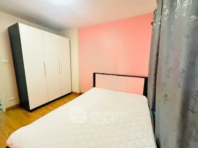 Cozy bedroom with modern wardrobe and stylish pink accent wall