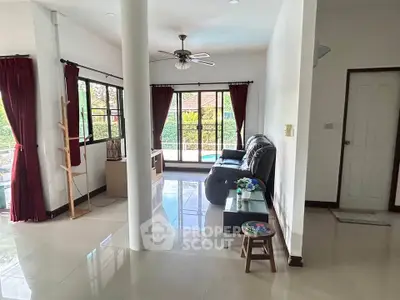 Spacious living room with large windows and elegant decor in a modern home.