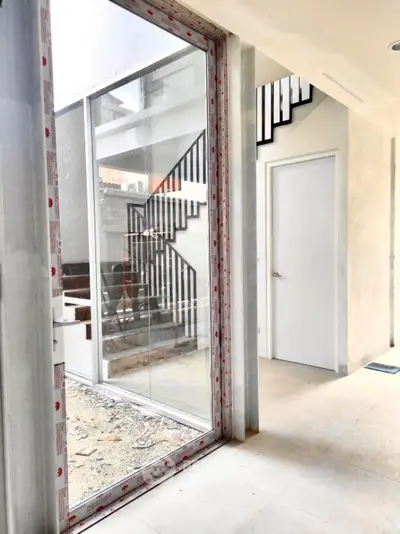 Modern interior with large window and staircase in new construction home