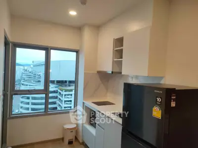 Modern kitchen with sleek appliances and city view from window