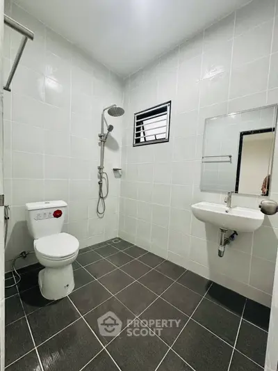 Modern bathroom with sleek tiles and contemporary fixtures in a real estate property.