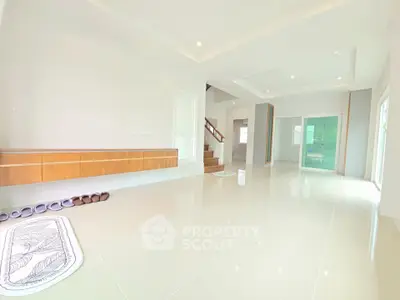 Spacious modern living room with sleek tile flooring and elegant wooden accents.