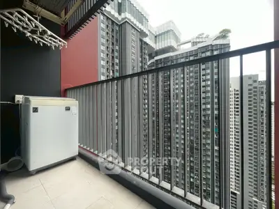 Modern high-rise balcony with cityscape view and washing machine