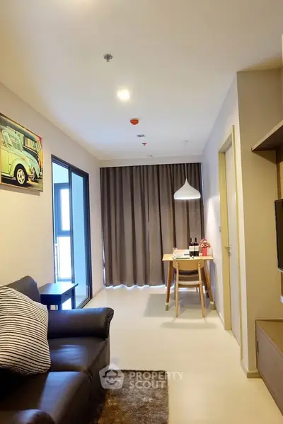 Modern living room with cozy seating and dining area, featuring stylish decor and natural light.
