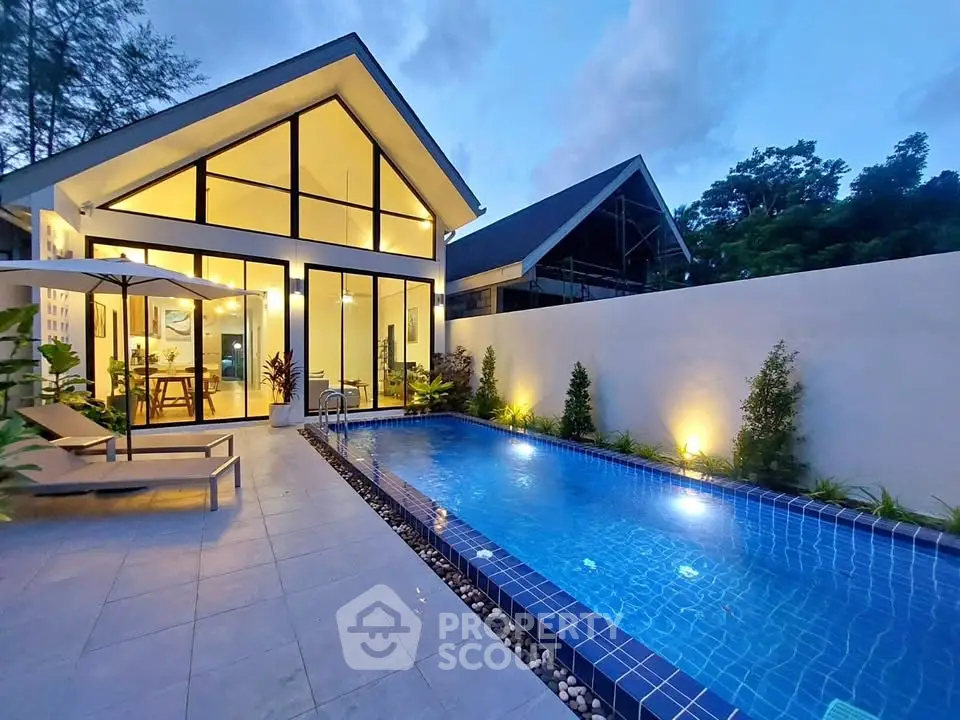 Stunning modern home with illuminated pool and sleek architectural design.