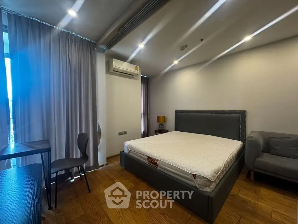 Spacious bedroom with modern furnishings and natural light