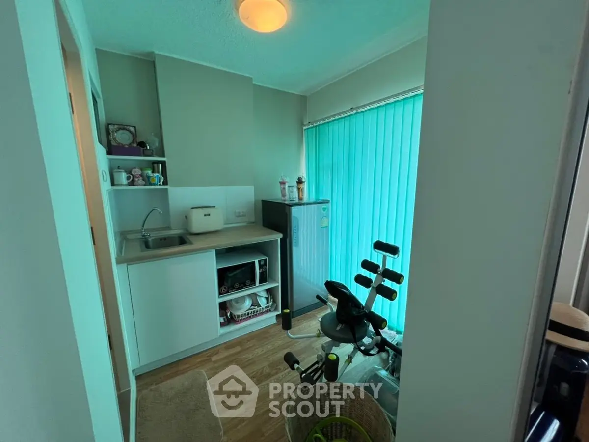 Compact utility room with exercise equipment and small appliances