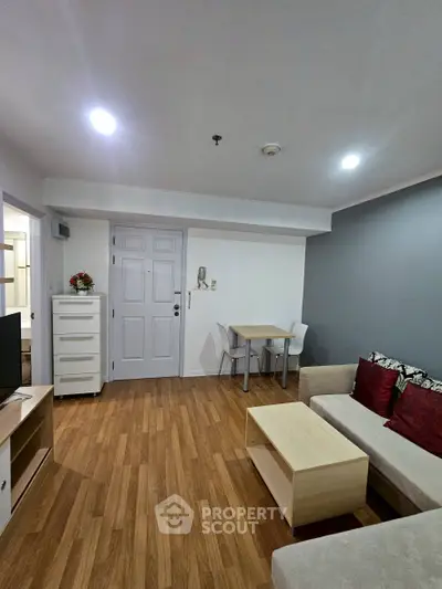 Modern living room with stylish furniture and wooden flooring in a cozy apartment.